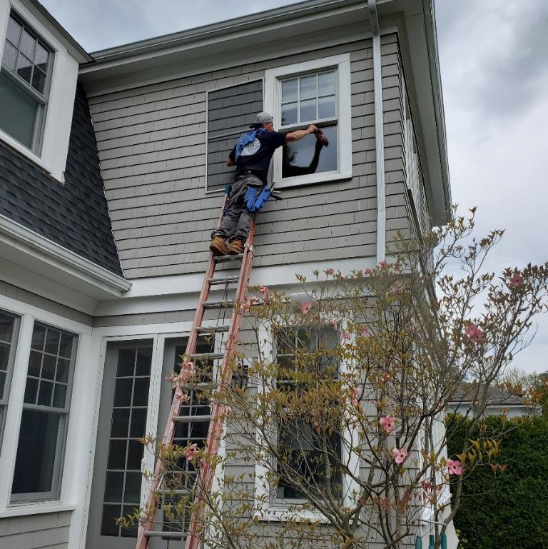 Windows Cleaning Experts cleaning a house window in Boston MA